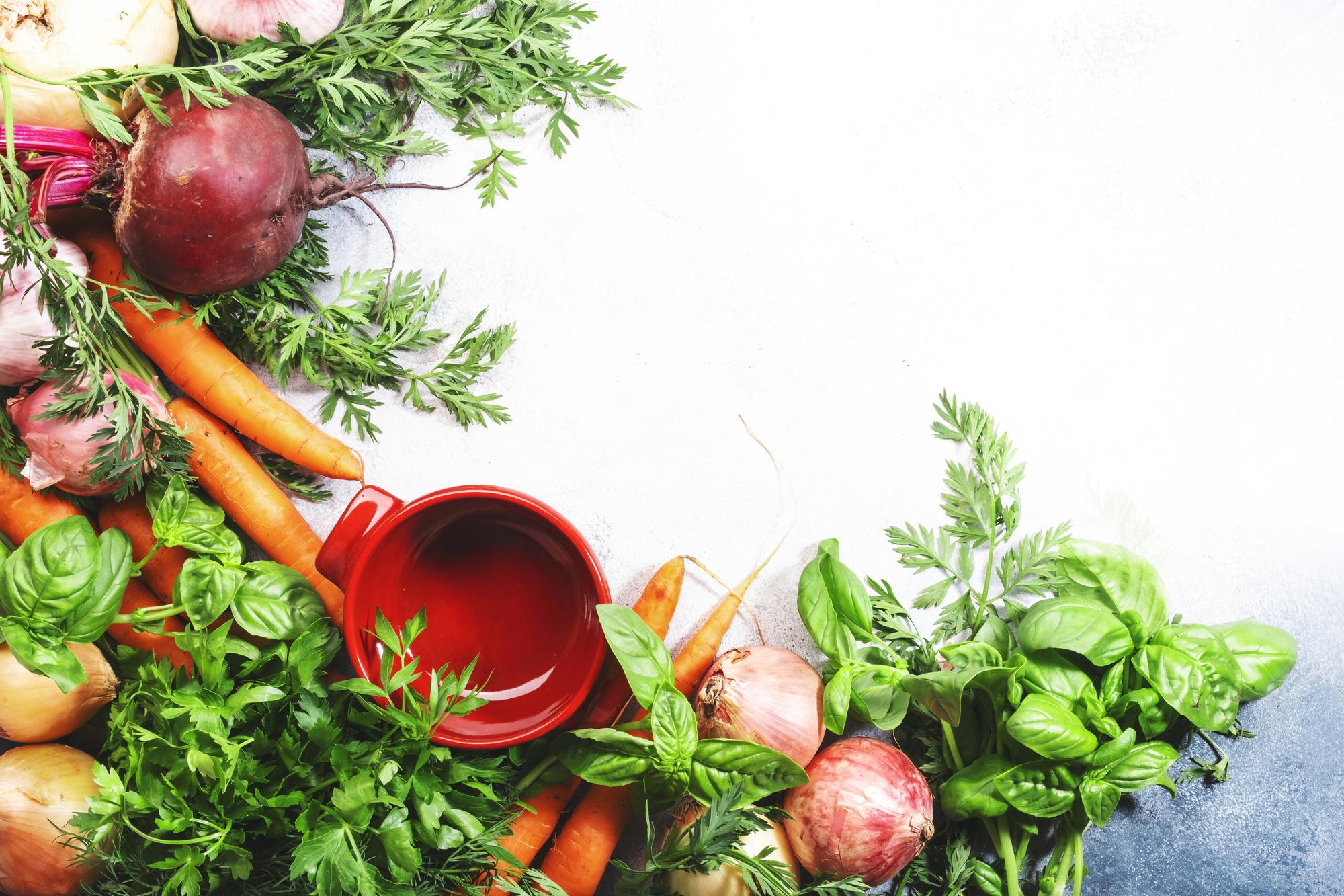 Variety of fresh vegetables and herbs on counter